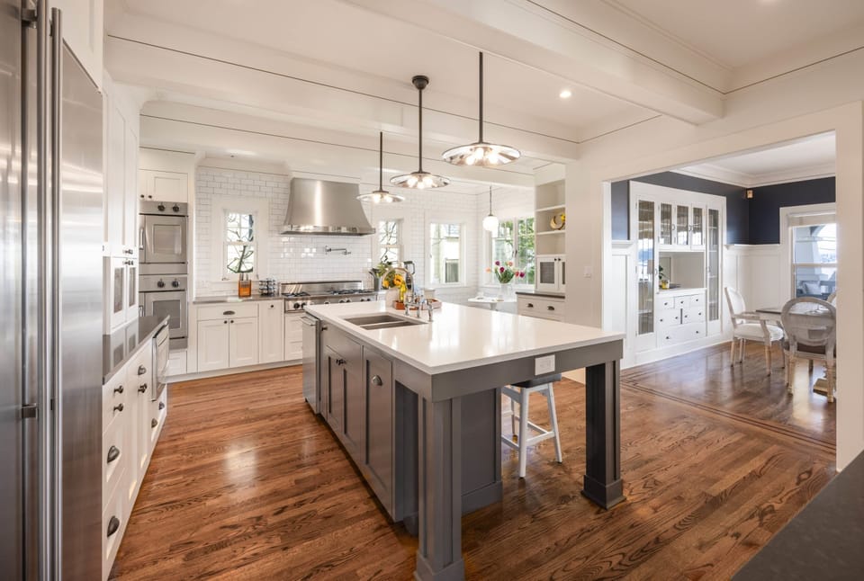  A built-in coffee and beverage bar with glass-front cabinets, a mini fridge, and a prep area. Perfect for morning coffee or evening refreshments in a sleek, organized space.
