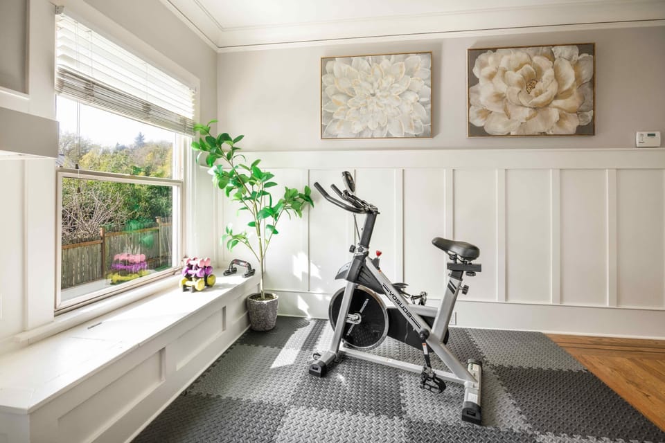 A dedicated area with an exercise bike, stylish decor, and plenty of light, ideal for keeping up with workouts during your stay.