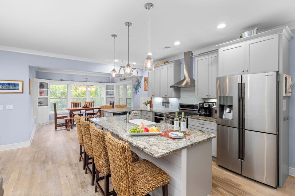 Kitchen and bar seating view, focusing on stainless steel appliances.