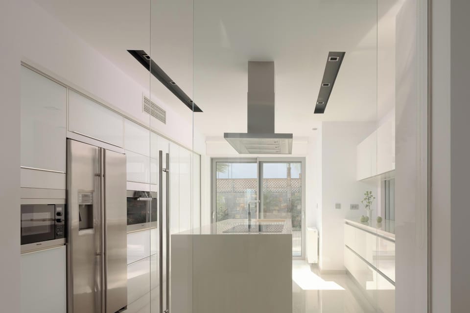 Fully equipped modern kitchen with a glass partition for privacy