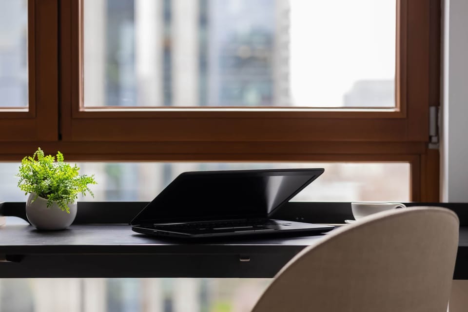 Minimalist workspace with desk and window view.
