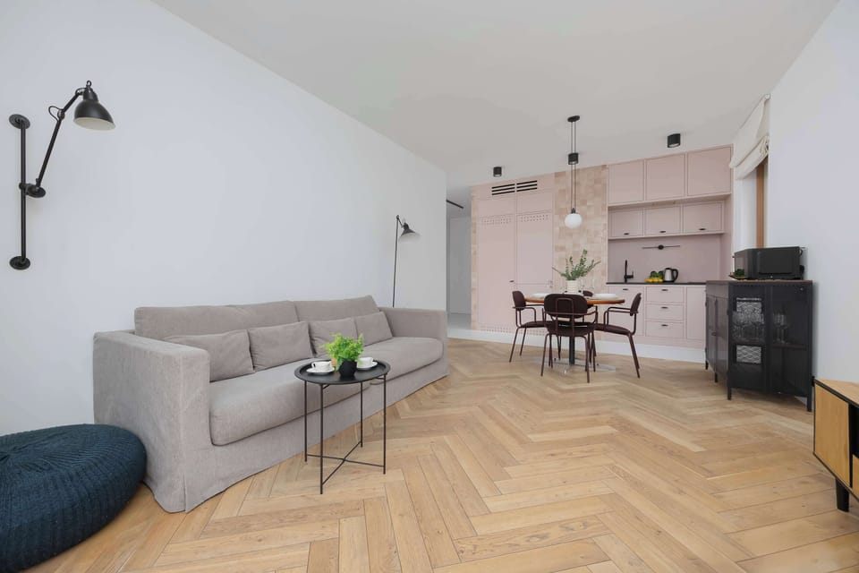 Spacious living room with large window and minimalist furniture.