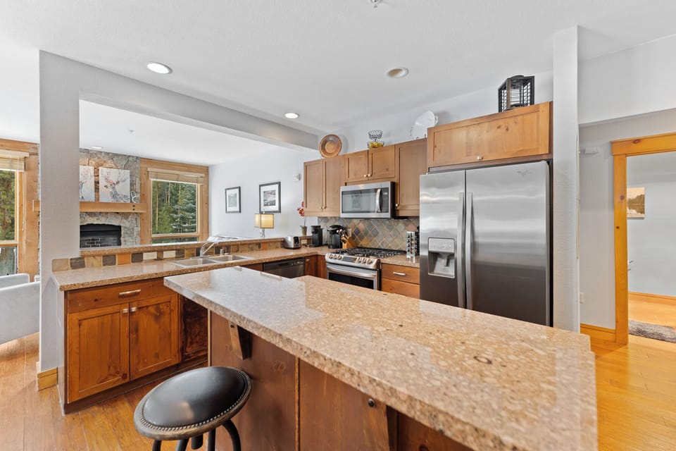 Your spacious mountain kitchen features granite counters, stainless appliances, and a breakfast bar perfect for morning coffee and meal prep.