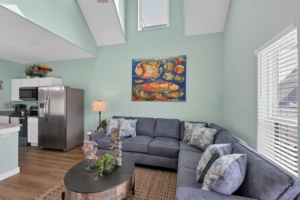 Sink into this spacious sectional sofa where you can unwind after beach days, with your full kitchen just steps away for easy meal prep.