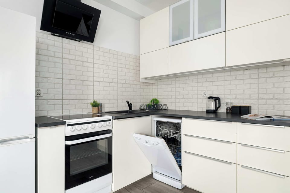 The sleek design of the kitchenette blending seamlessly with the living area.