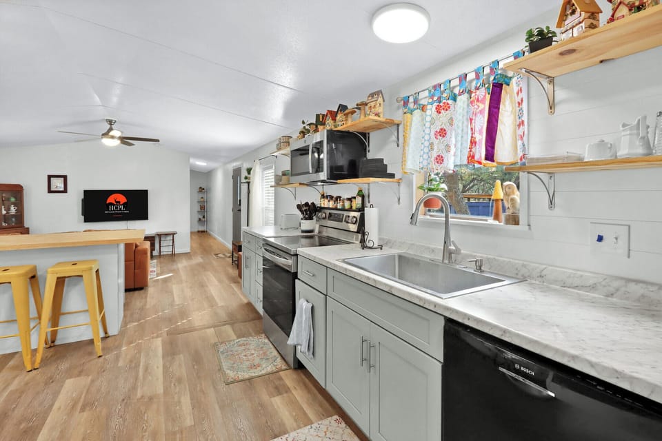 The kitchen is behind the living room