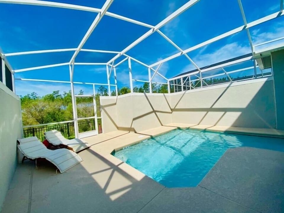 Your private screened pool awaits with sparkling blue water and comfortable loungers for soaking up the Florida sunshine in complete privacy.