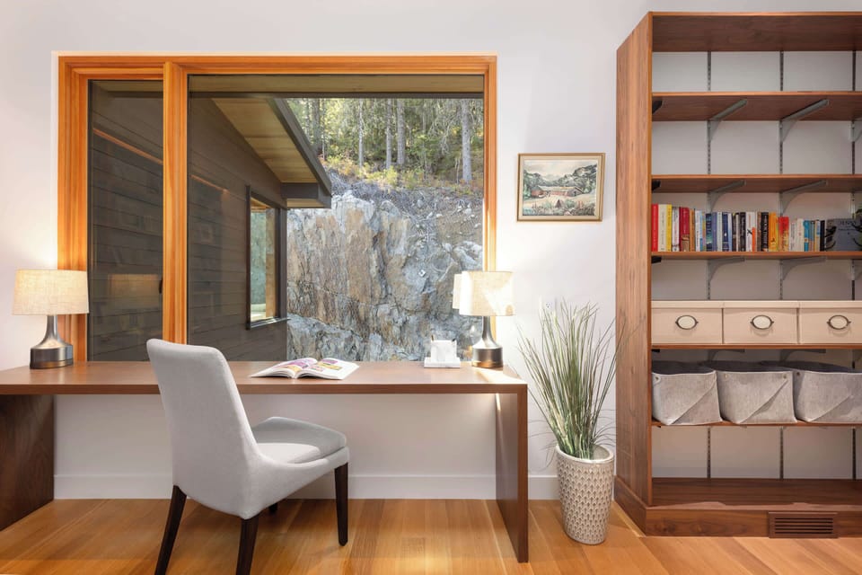 Upper-level office w/ built-in shelving and a quiet setup for focused work or reading.