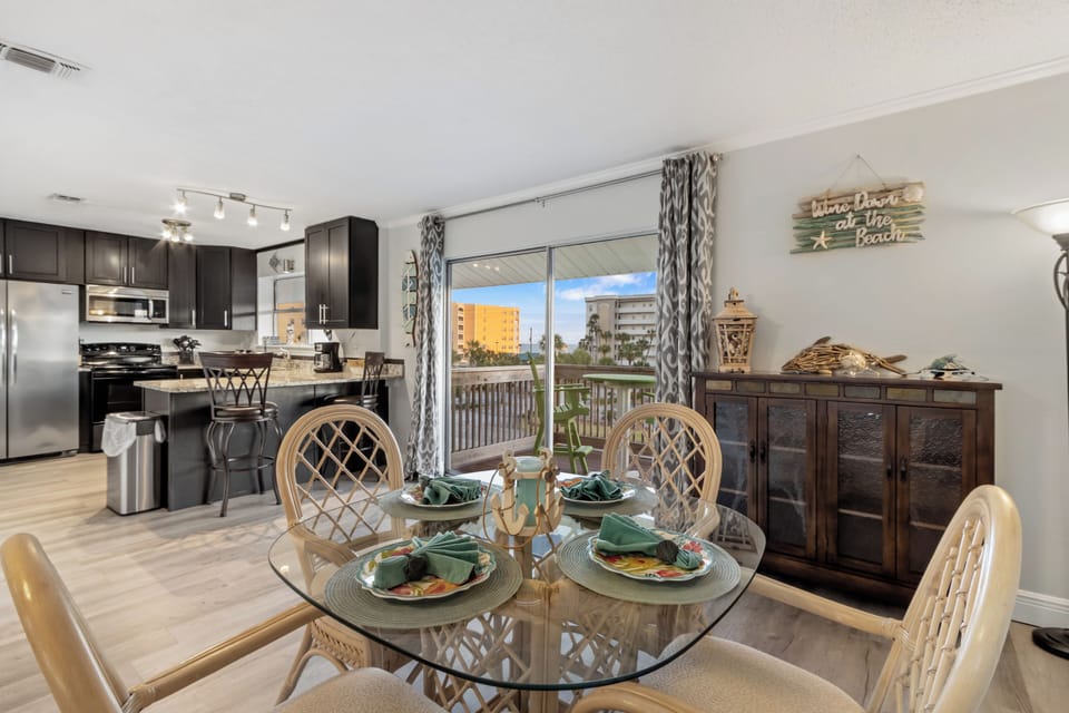 Coastal dining space with open layout and balcony access.
