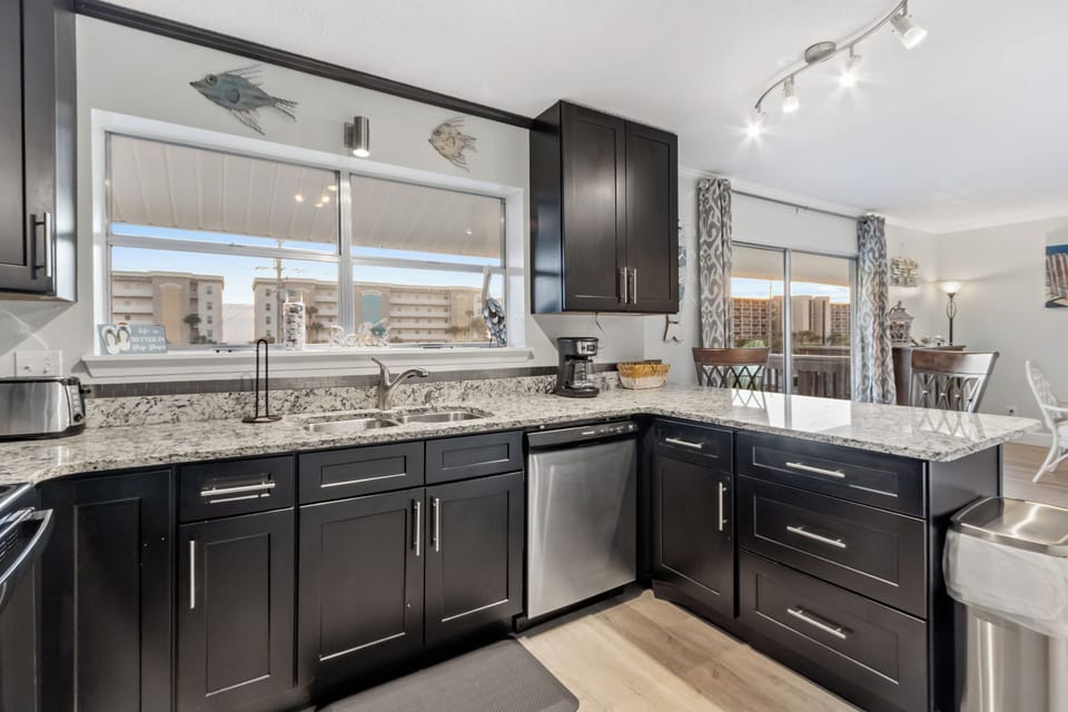 Fully equipped kitchen with granite countertops, modern appliances, and plenty of prep space for meals at home.