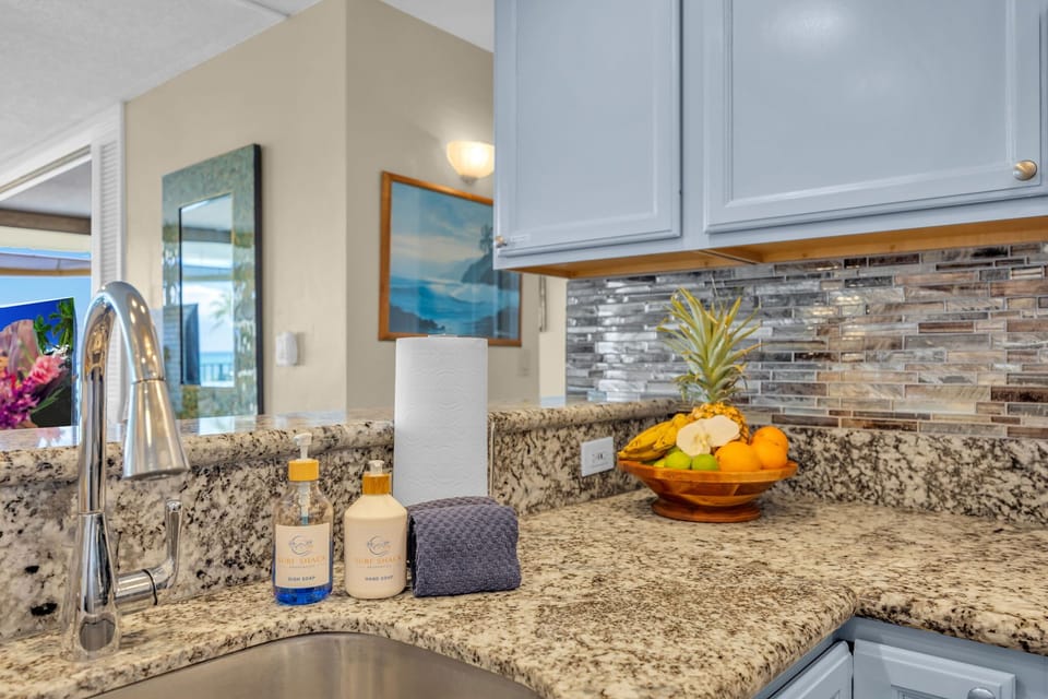 Premium granite countertops paired with a deep sink, modern faucet, and fresh island touches. 