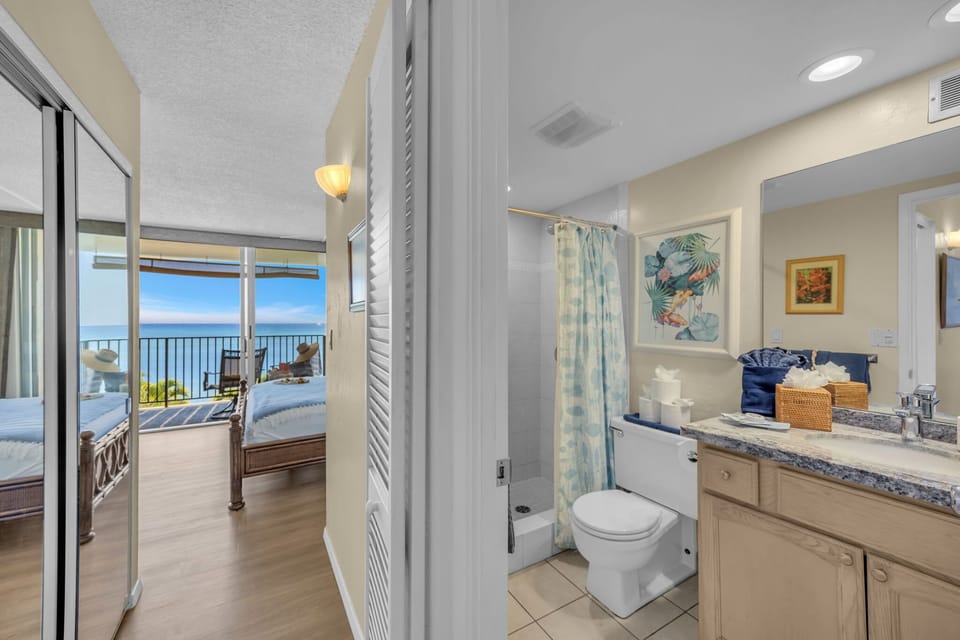 Bathroom with step-in shower, eco-friendly refillable tropical shampoo and conditioner, towels, toilet paper, tissues, etc provided