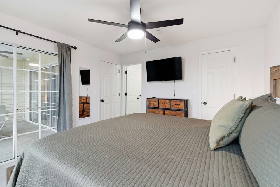 Recharge in the second bedroom, offering a stately king bed, smart TV & deck access​