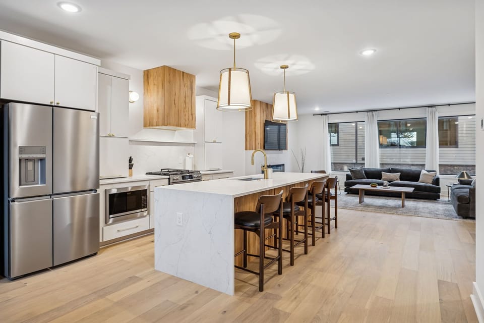 Kitchen: Sleek lines, warm tones, and high-end touches — the perfect kitchen for cooking, entertaining, and enjoying life together.