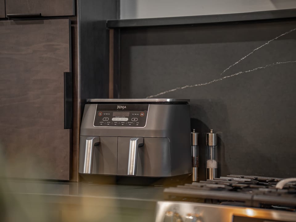 Kitchen: Sleek lines, warm tones, and high-end touches — the perfect kitchen for cooking, entertaining, and enjoying life together.