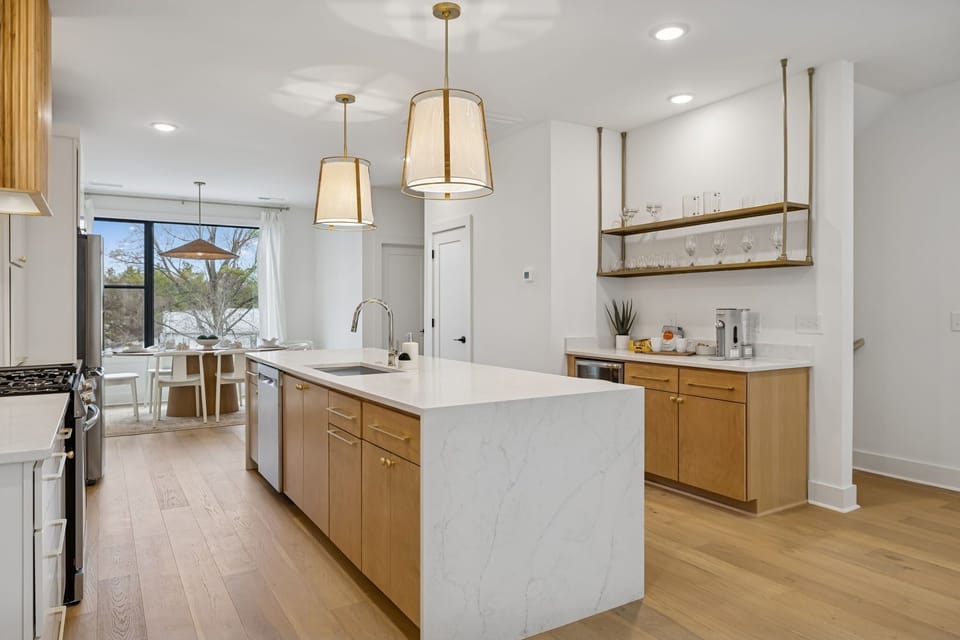 Kitchen: Sleek lines, warm tones, and high-end touches — the perfect kitchen for cooking, entertaining, and enjoying life together.