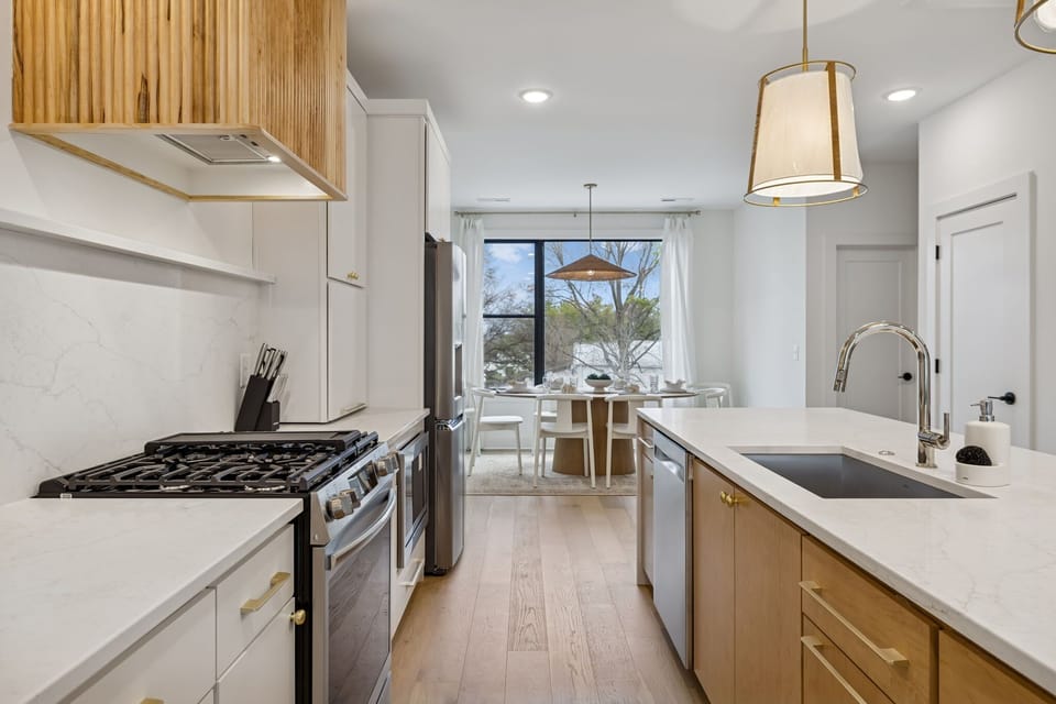 Kitchen: Sleek lines, warm tones, and high-end touches — the perfect kitchen for cooking, entertaining, and enjoying life together.