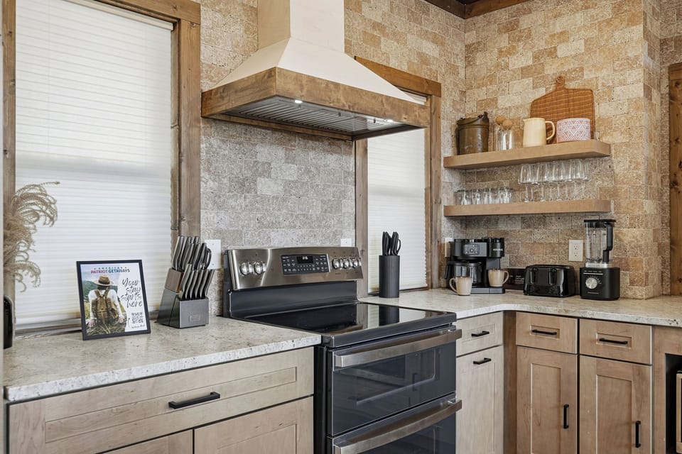 You'll love cooking in this warm, rustic kitchen with exposed brick walls, granite counters, and everything needed for your perfect meal.