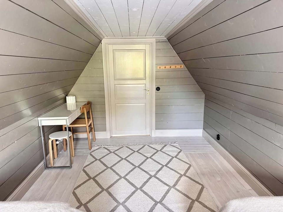 View Bedroom 2. There is a desk and small seating area.