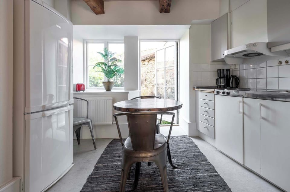 The kitchen with a dining area and beautiful natural light.