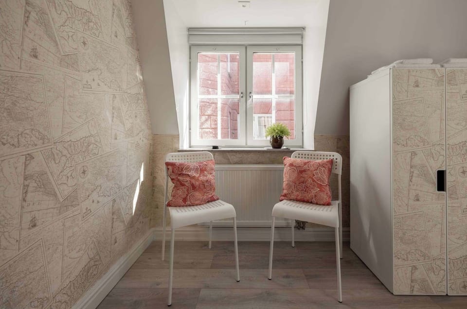 Unique bedroom with sitting area and several wardrobes.