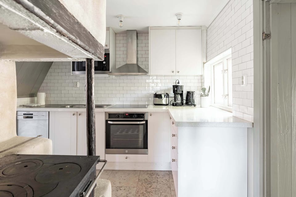 The fully equipped kitchen with all essentials you will need for a home cooked meal. There is a stove, oven, dishwasher, microwave, kettle, toaster, coffee maker and essentials. 