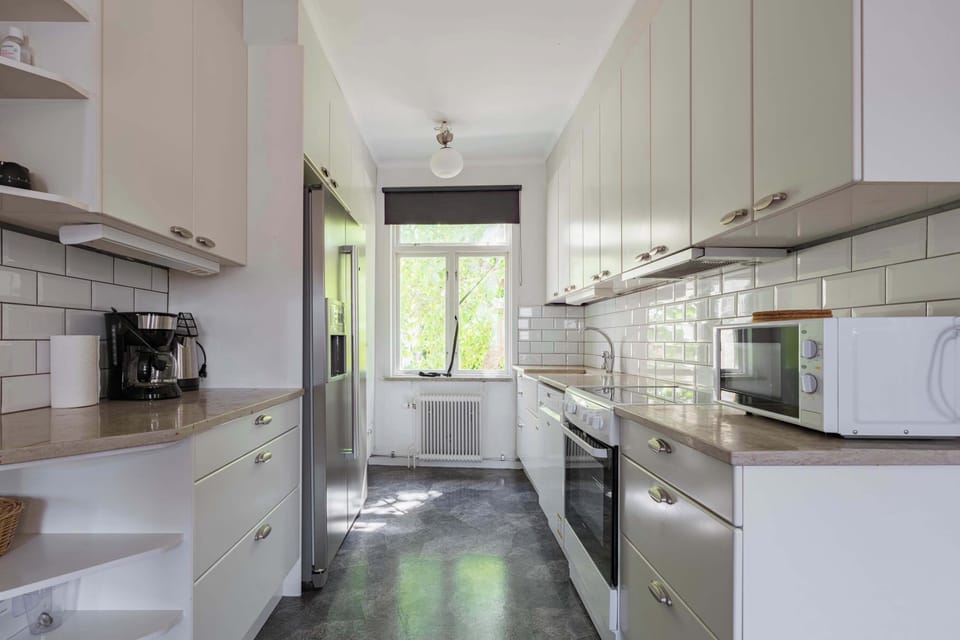 A fully equipped kitchen with all essentials you will need for a home cooked meal. There is a stove, oven, fridge, freezer, coffee maker, kettle and silverware.