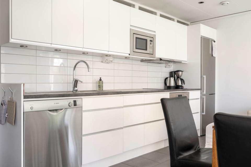 Another view, also showcasing the modern, fully equipped kitchen.