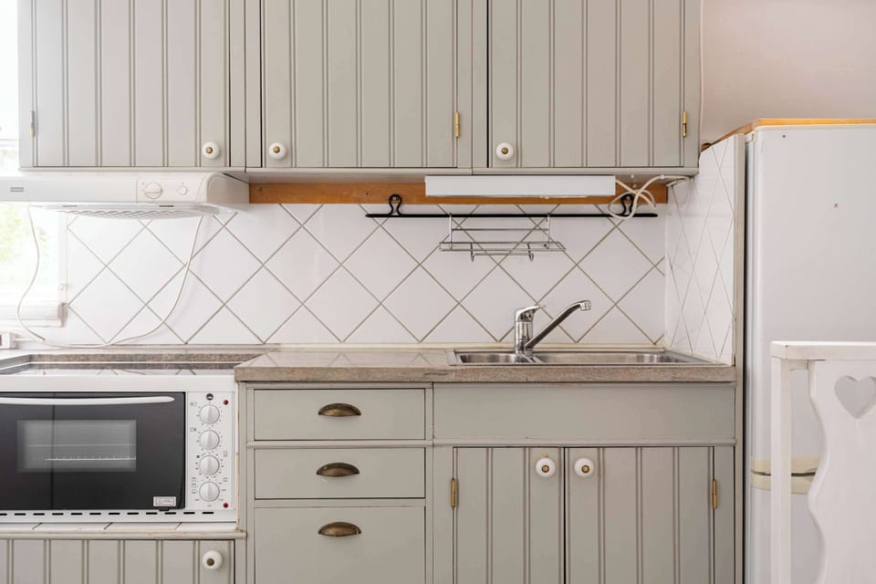 Closer view of the fully equipped kitchen with all essentials you will need for a home cooked meal. There is a stove, oven, dishwasher, fridge, freezer, microwave, kettle and coffee maker.