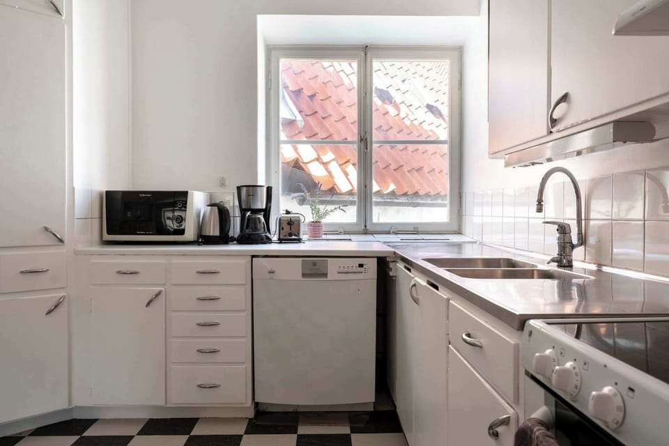 A fully equipped kitchen with dishwasher and microwave.
