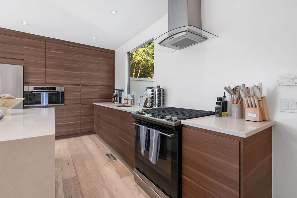 Kitchen — Walnut Cabinetry, Range & Vent Hood