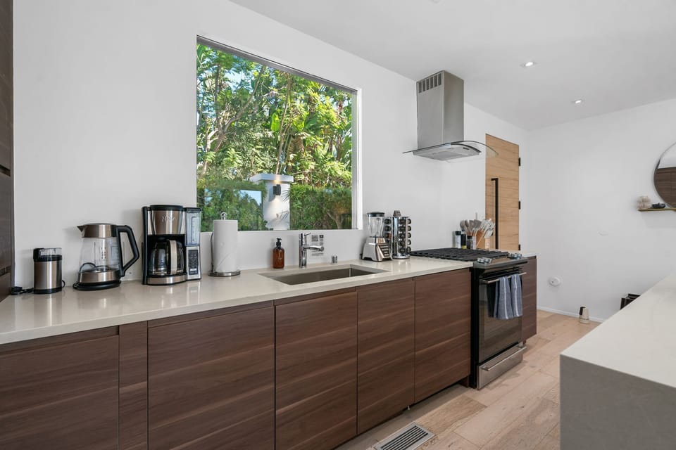 Chef's Kitchen — Walnut Cabinetry, White Countertops & Garden Window