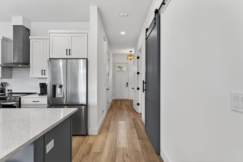 An inviting kitchen boasts modern appliances and a spacious island, perfect for entertaining and gathering with friends and family.