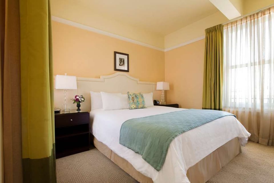 Relax in our inviting room with a luxurious queen bed, tasteful decor, and ample natural light for a soothing ambiance.