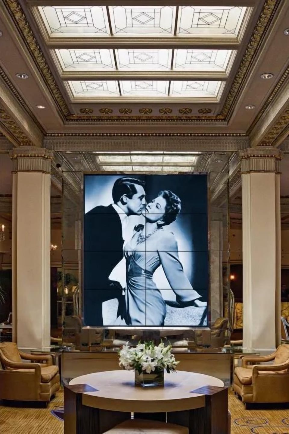 The grand lobby area is adorned with luxurious furnishings and exquisite artwork, offering a serene space for guests.