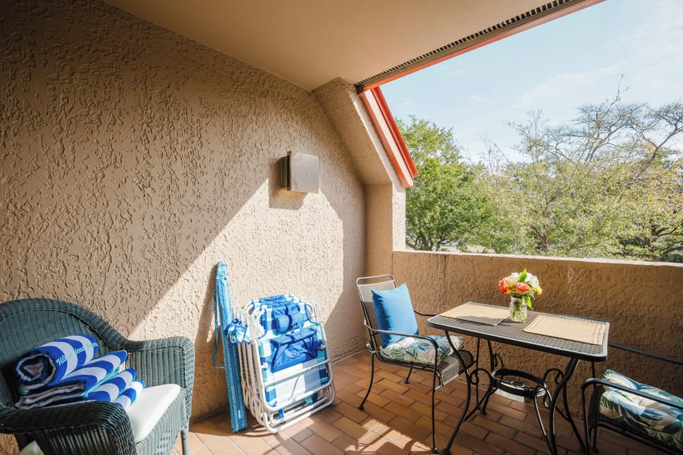 Seating on the balcony, 4 beach chairs, towels, umbrella and wagon.