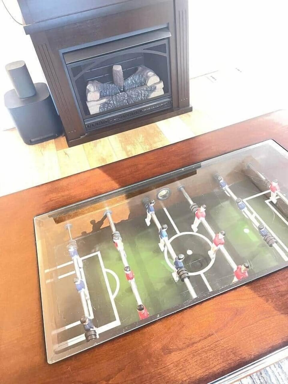 A unique foosball coffee table brings a playful touch and entertainment to the heart of your cabin.