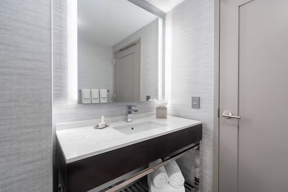 Refresh at a bright vanity with plush towels and space.