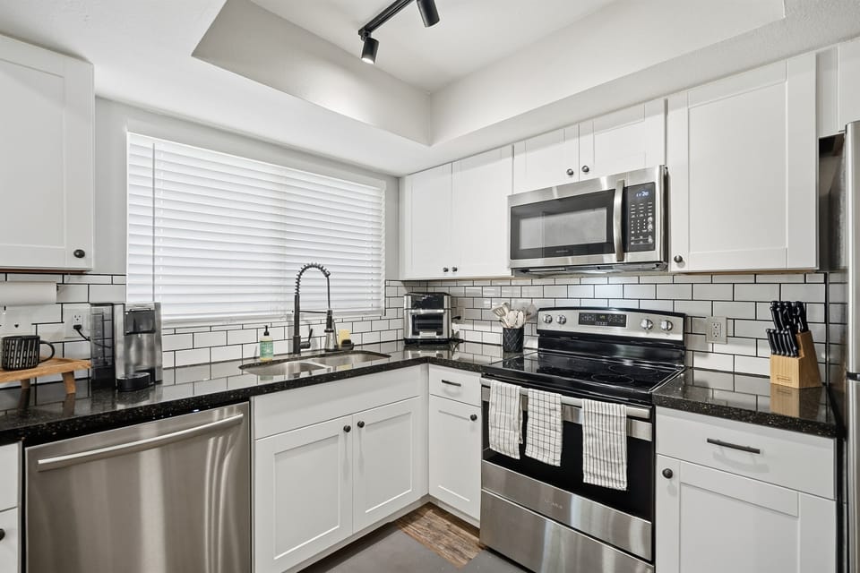 Enjoy a bright, modern kitchen with sleek stainless steel appliances and everything you need to cook and feel at home.