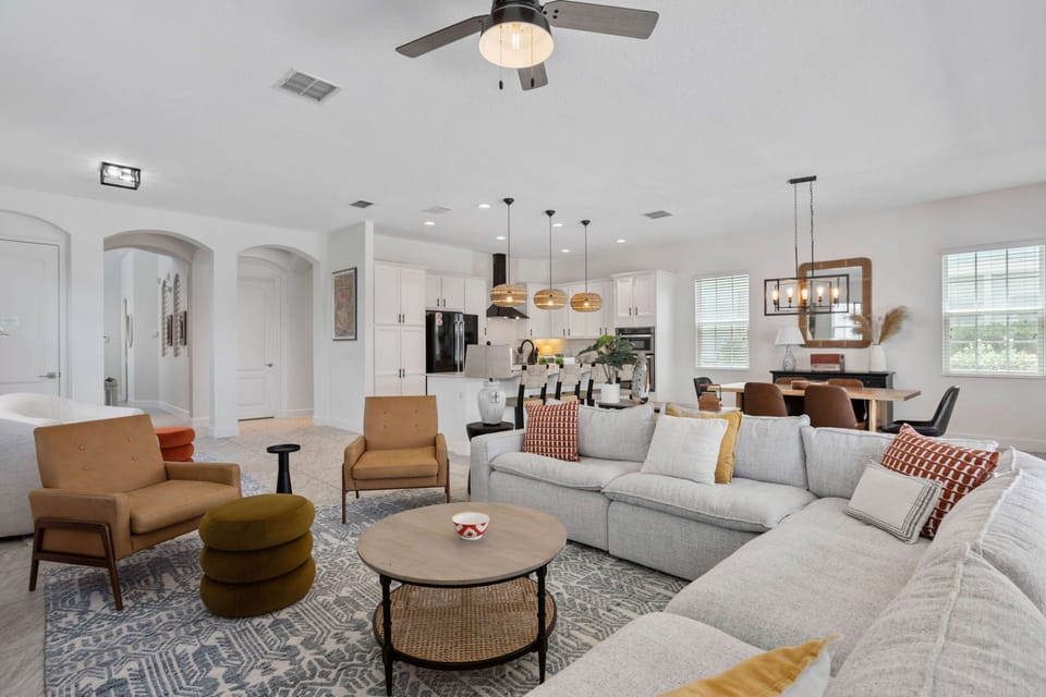 Comfortable living room featuring a large sectional sofa, stylish décor, and an inviting layout for movie nights.