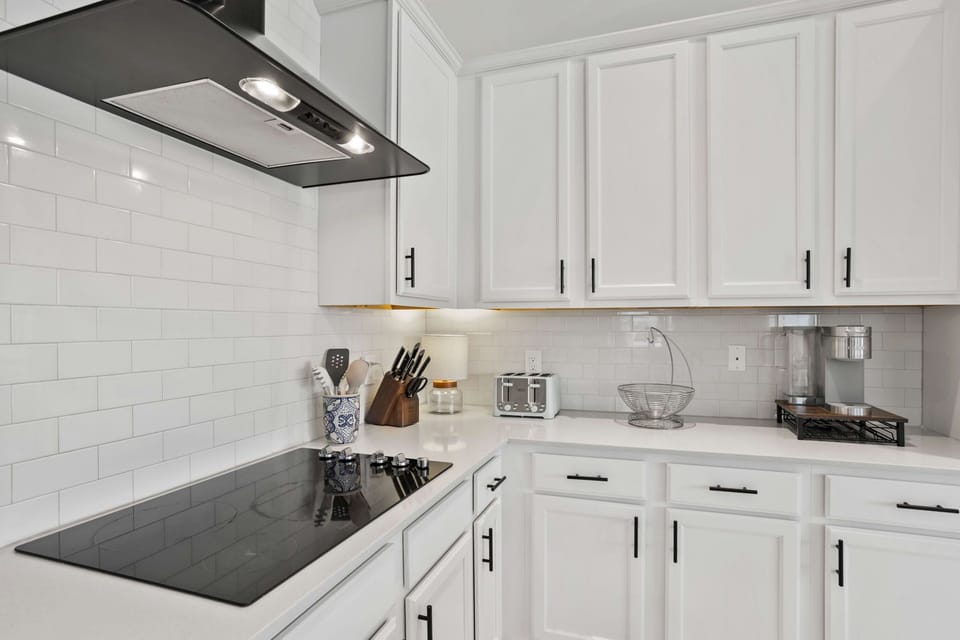 Sleek cooktop and backsplash detail highlighting the home’s modern finishes and attention to detail.