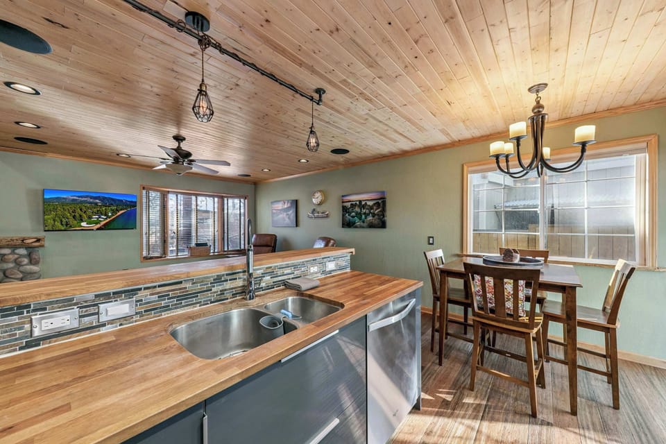 Open kitchen and dining area with warm wood finishes and natural light—perfect for shared meals, morning coffee, and easy gatherings.
