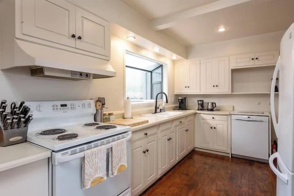 Clean, well-equipped kitchen with ample counter space and natural light—perfect for home-cooked meals, coffee rituals, and easy entertaining.
