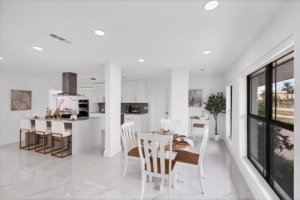 Dining area. Dining table seats 4 with additional seating at kitchen island, bar top table, and kitchen nook area