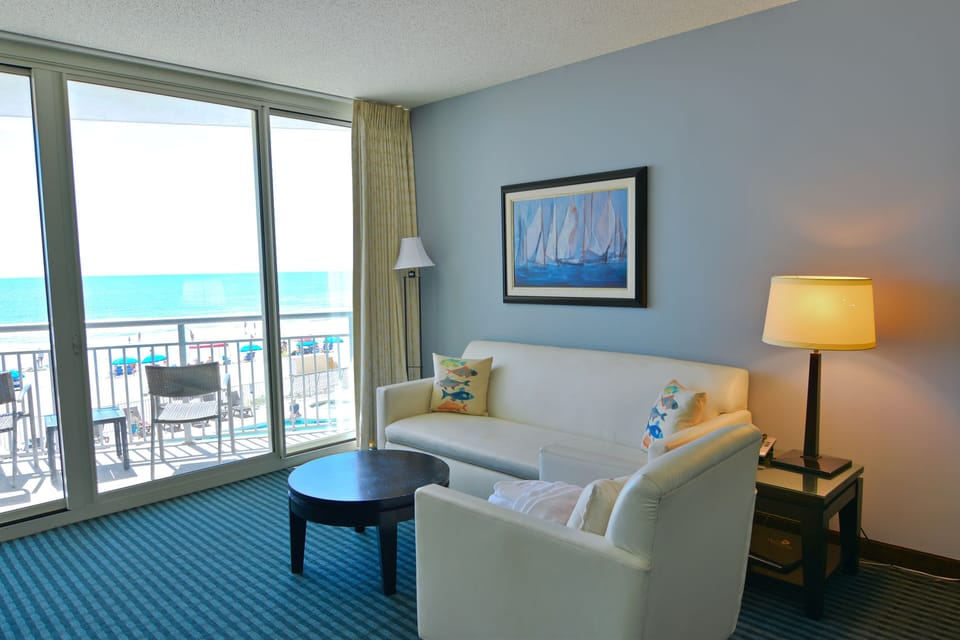 Spacious living room with ocean view and nautical accents.