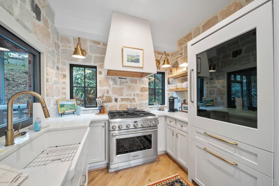 Kitchen with Stone Work, Gas Stove, and Custom Appliances