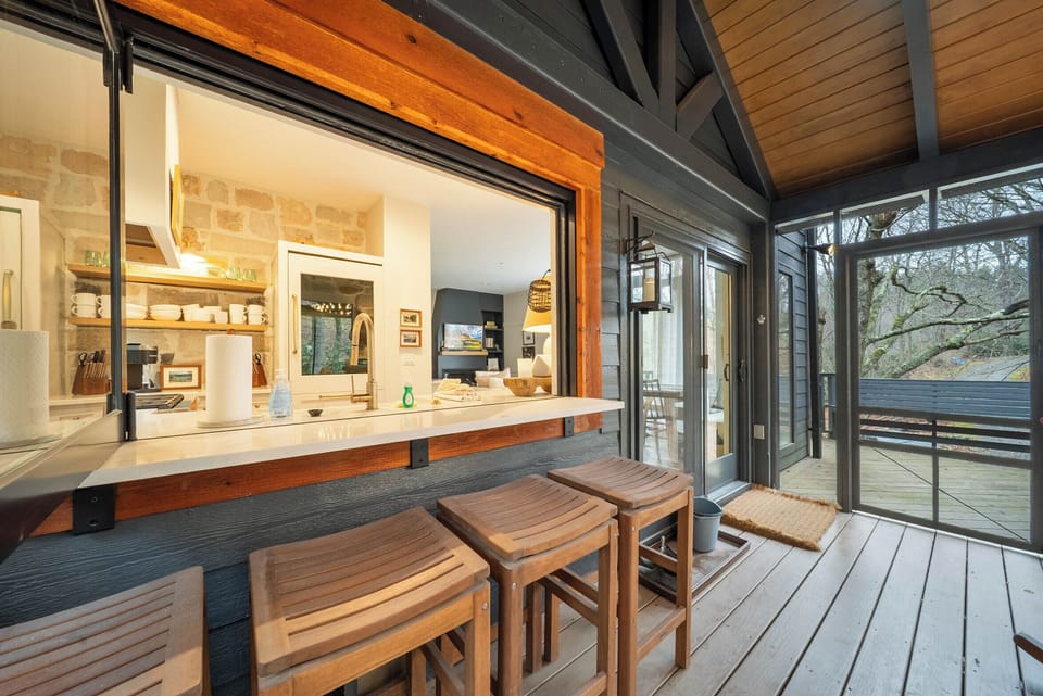Window Opens from Enclosed Porch to Kitchen, Bringing the Spaces Together