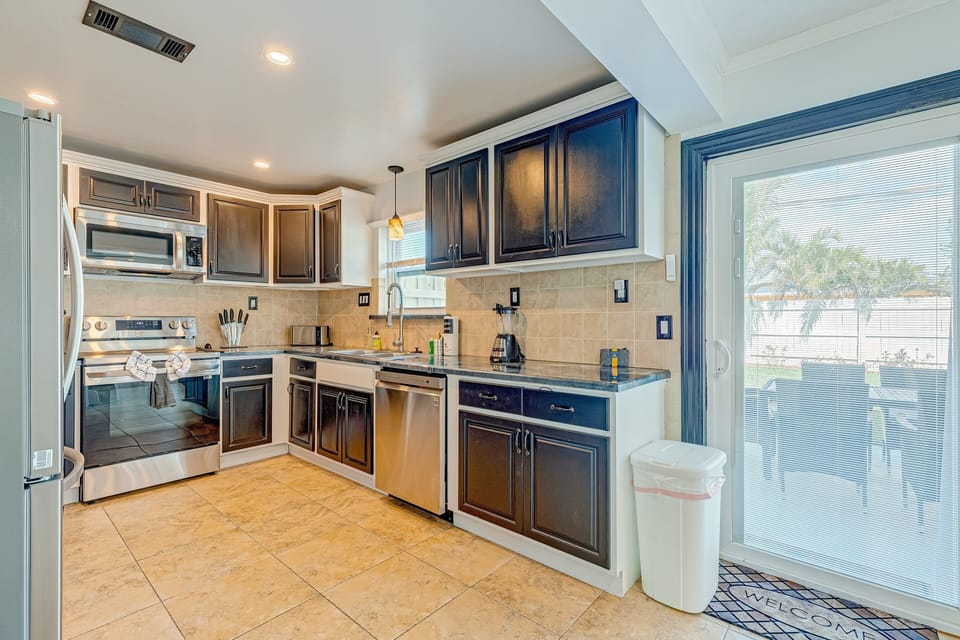 The kitchen features convenient access to the private back yard patio area.