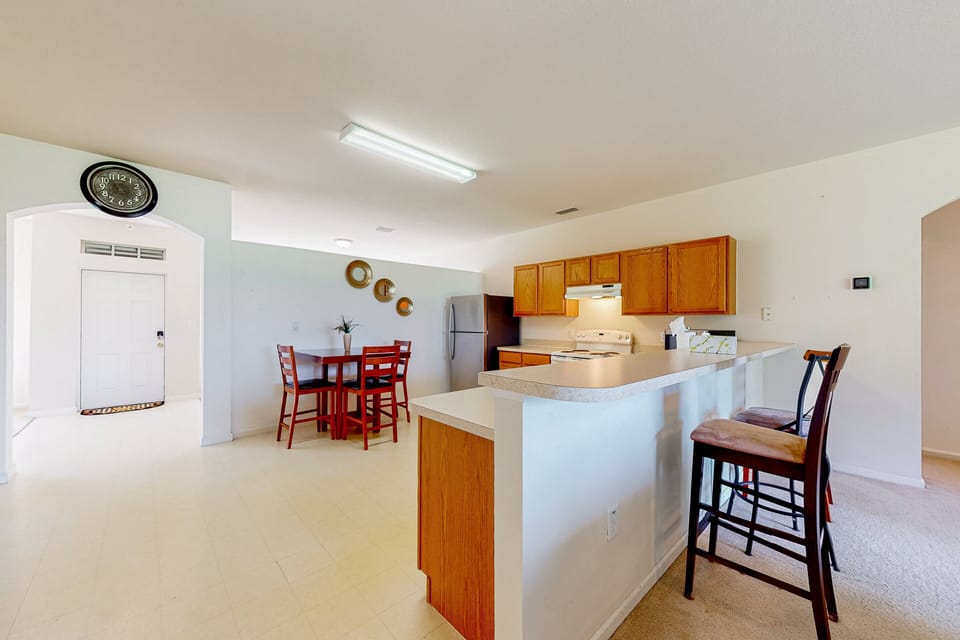 The kitchen is featured in the large open floor plan with fridge, oven, stove, microwave, dishwasher, and breakfast table.