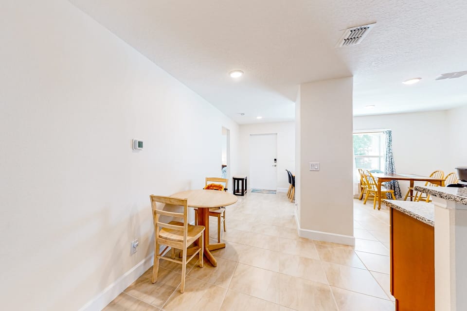 The kitchen nook has seating for two and is a transition from the kitchen to living room.